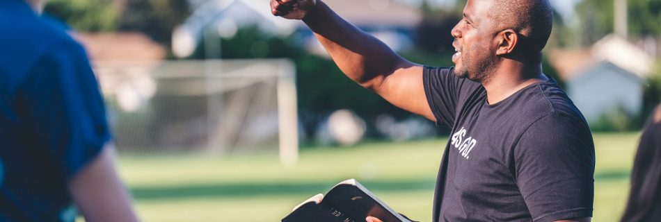 man in black crew neck t-shirt holding black tablet computer