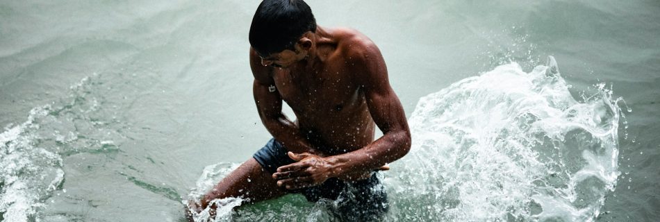 topless man in the water