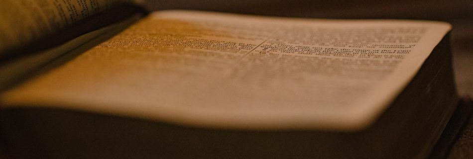 an open book sitting on top of a wooden table